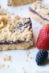 single raspberry shortbread bar with berries